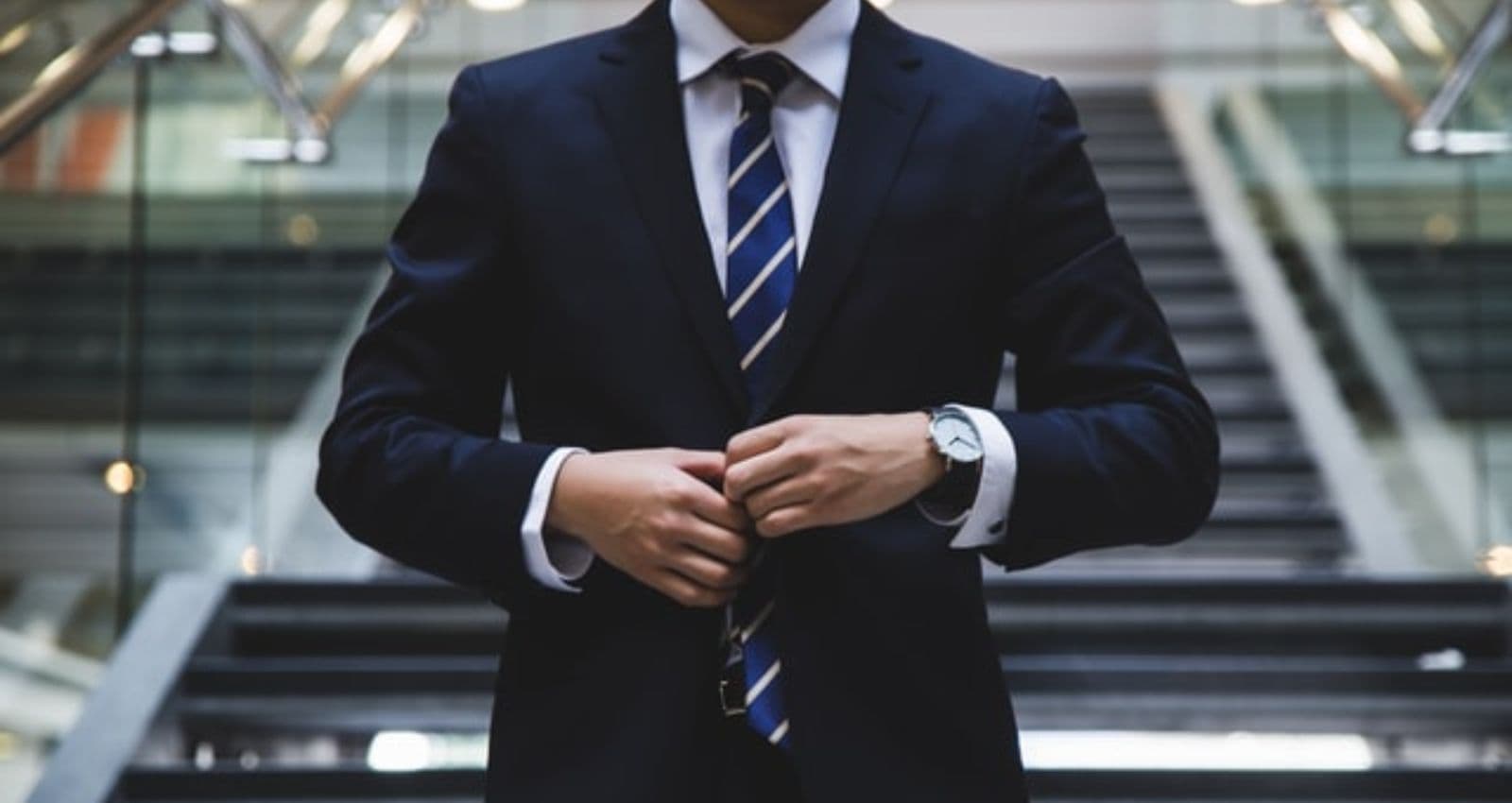 person standing near stairs in a blue suit